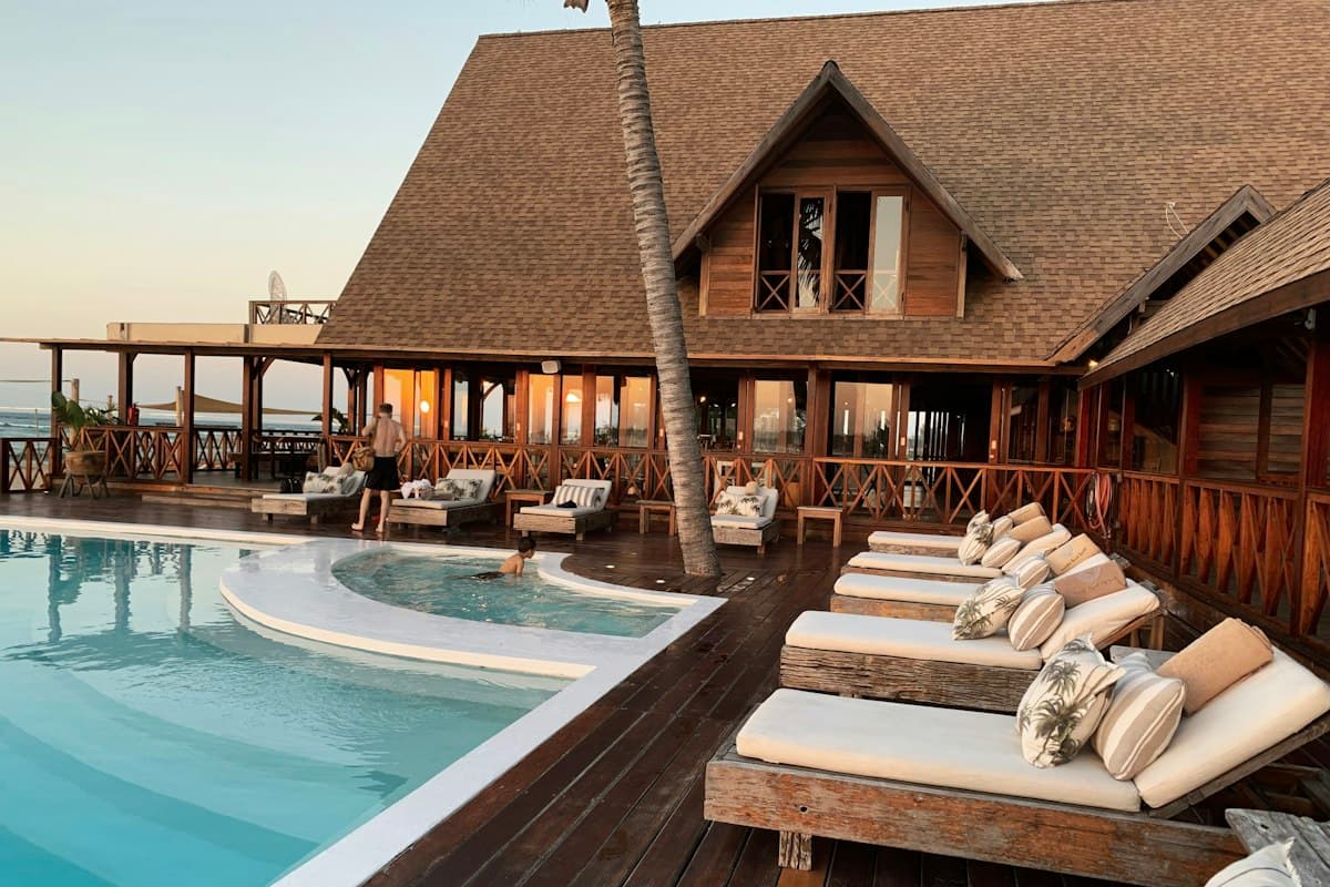 Resort pool deck with loungers at sunset